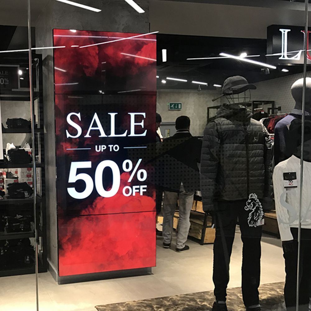 A store with a sign that says sale up to 50 % off