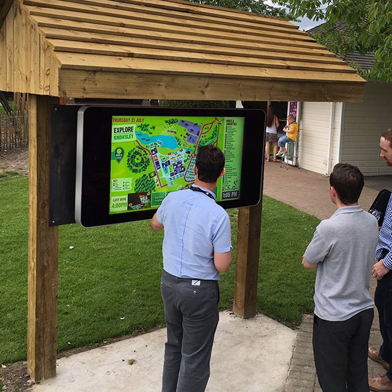 A group of people looking at a map on a screen