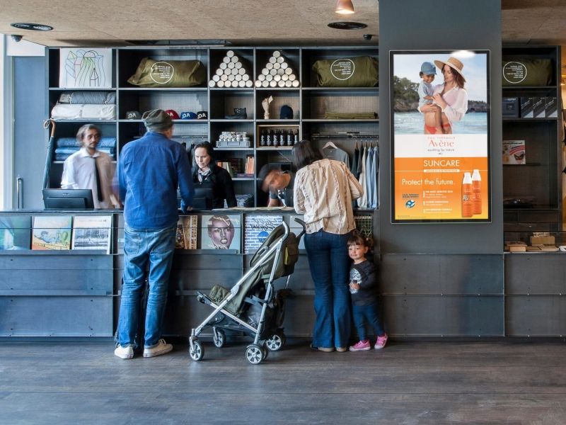 A group of people are standing at a counter in a store