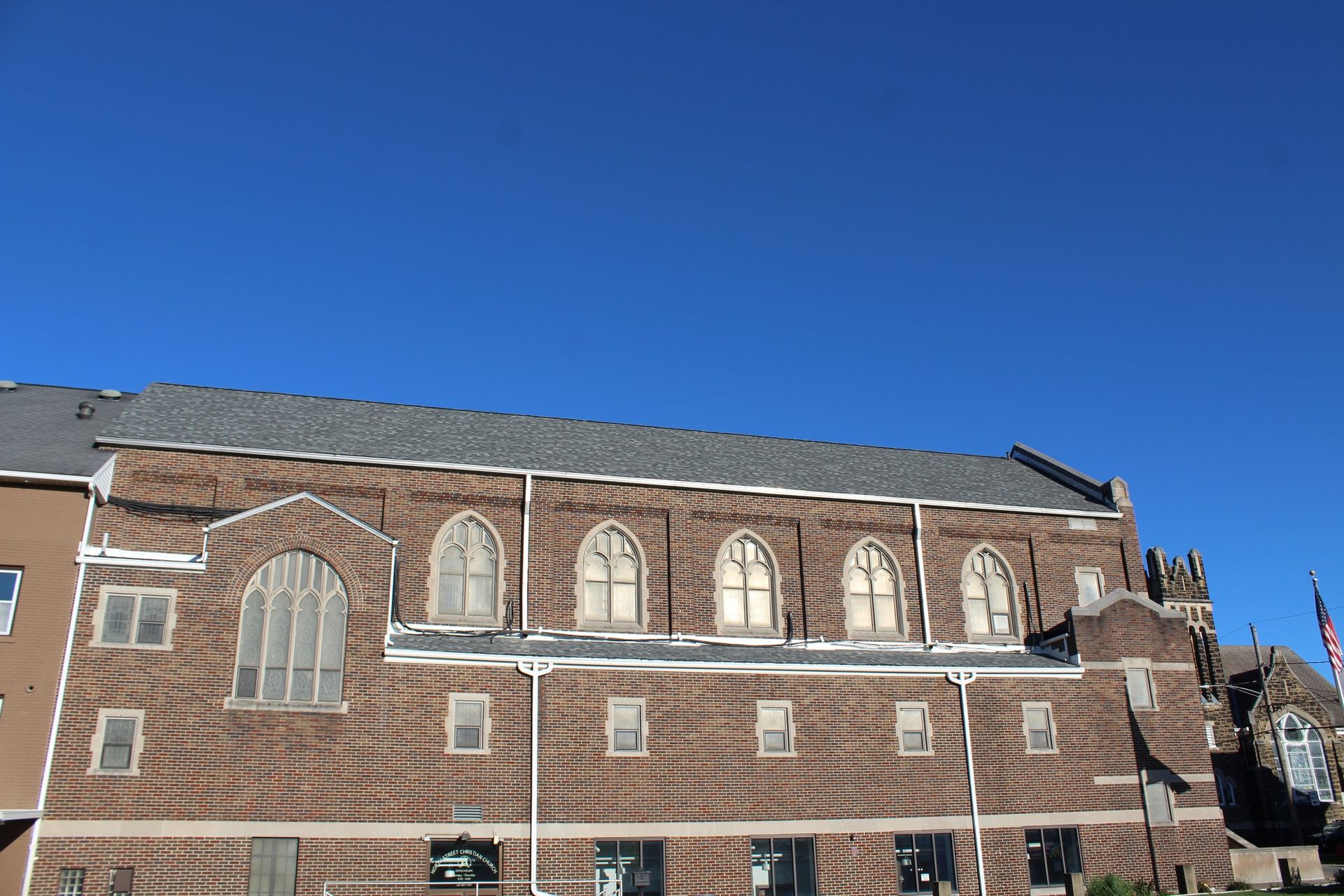 A large brick building with a blue sky in the background