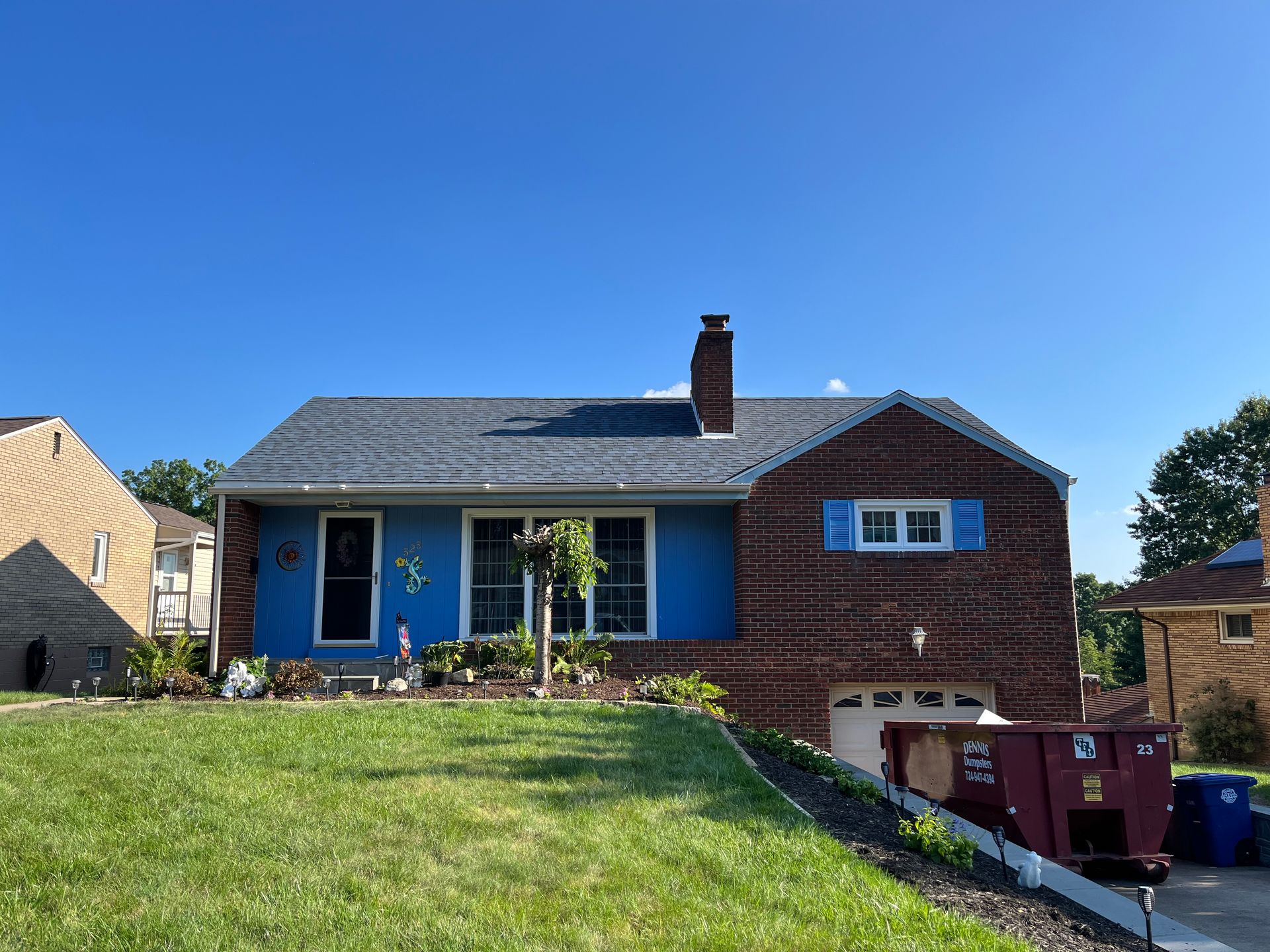 New asphalt shingle roof installation on a residential brick home