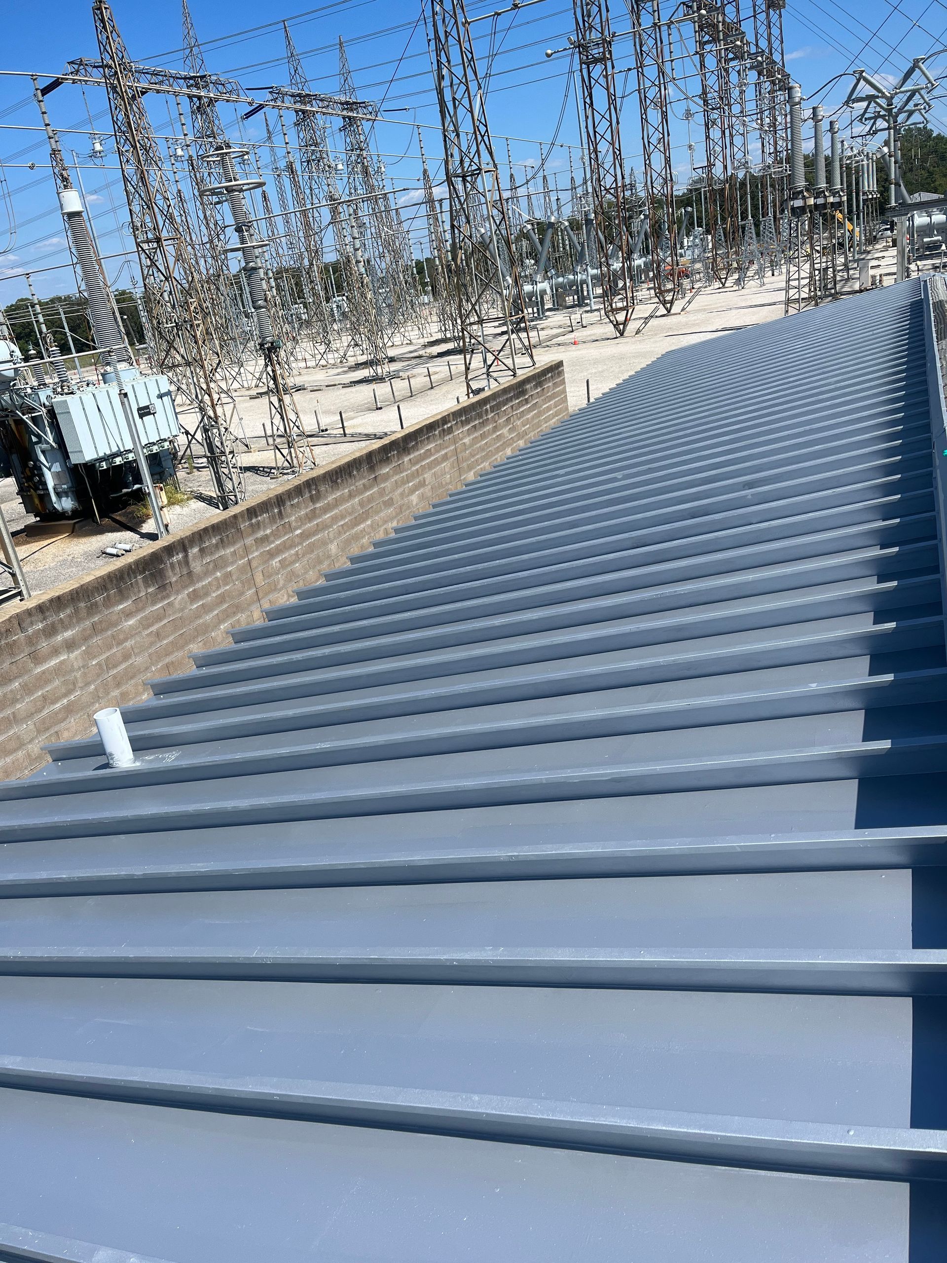 a newly coated metal roof inside a substation