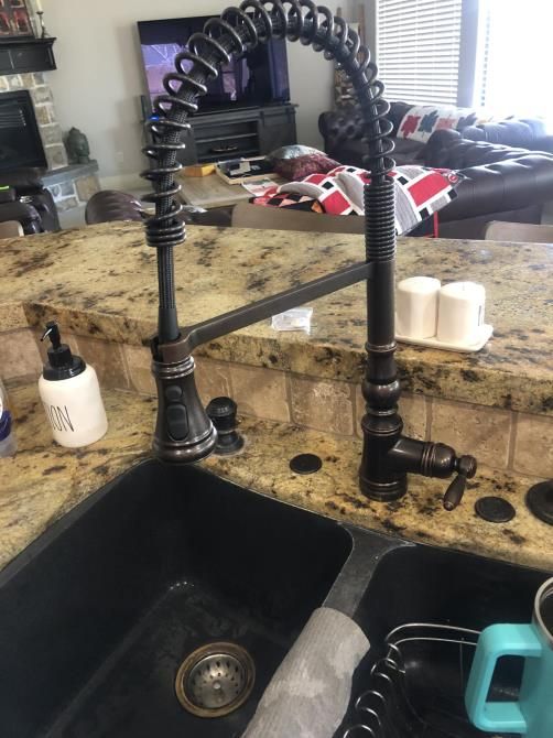 a plumber is working under a sink in a kitchen