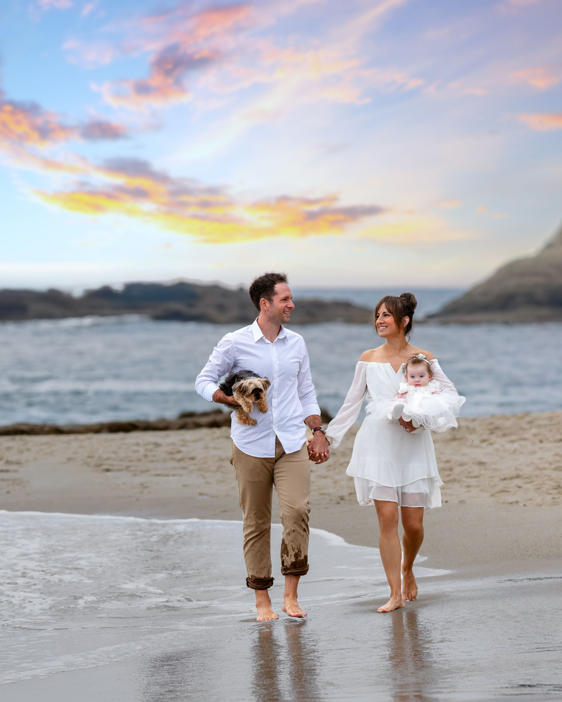 Portrait of a couple walking on the beach.