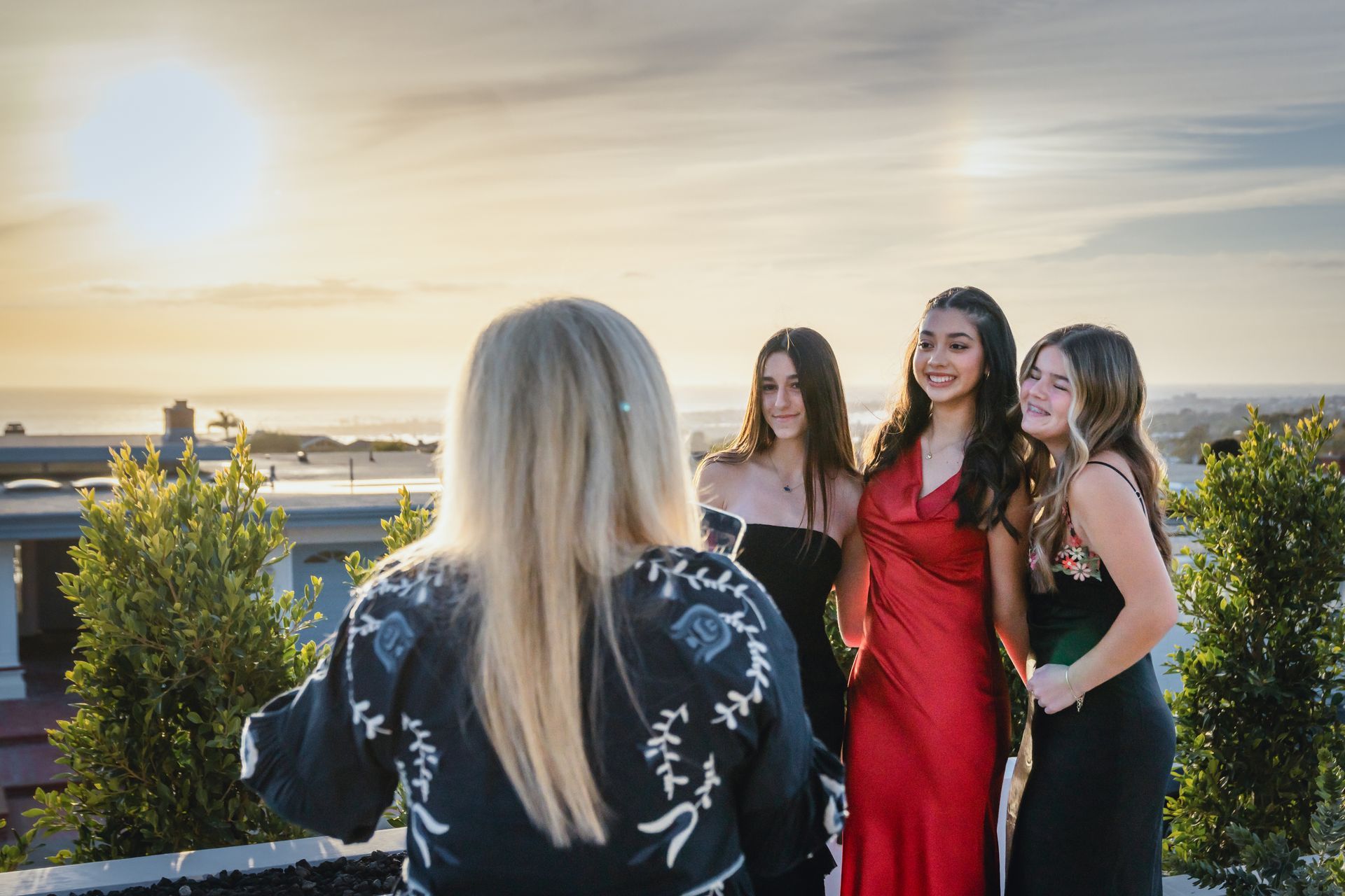 A parent taking photos of their child for school Winter Formal Dance.