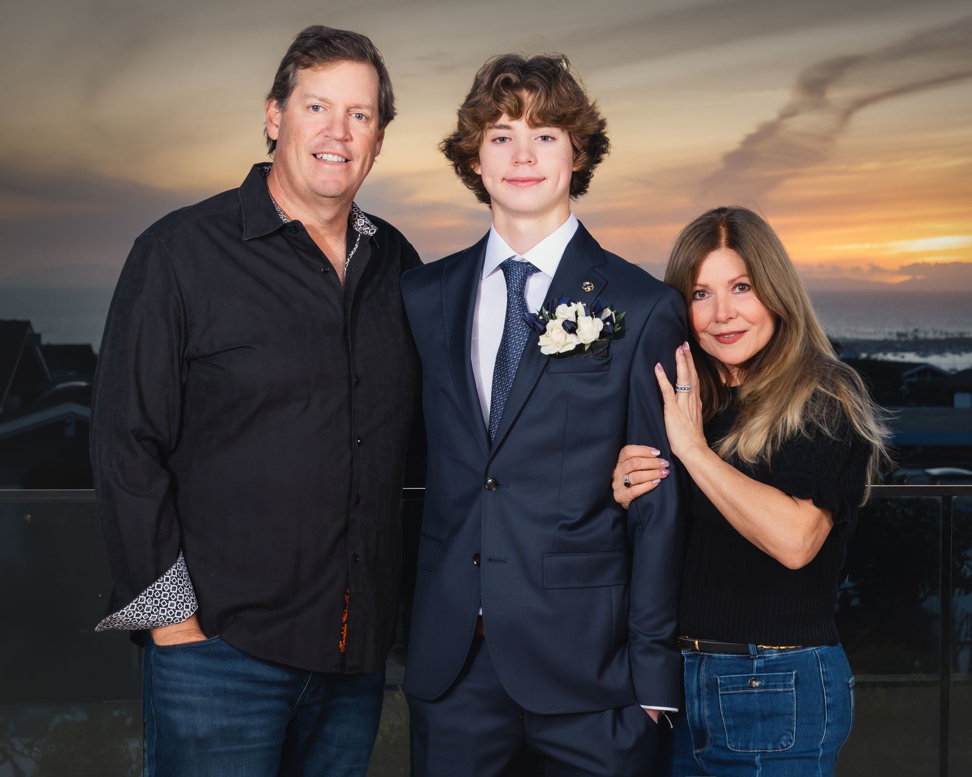 Actors in traditional folk costumes—long skirts, aprons, headscarves, and floral crowns—perform a lively dance with clapping on stage.