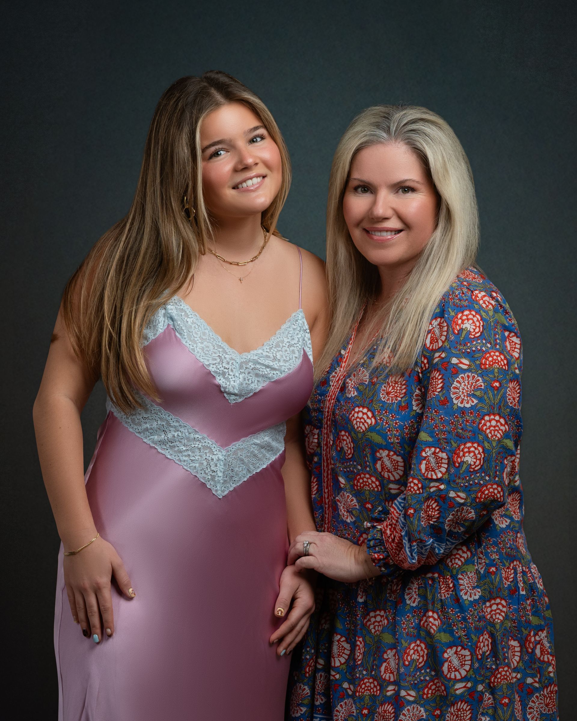 A studio portrait of a mom and daughter