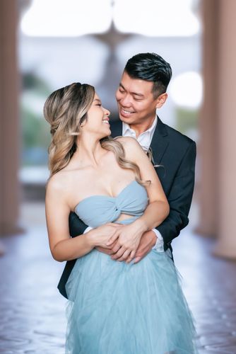 A lifestyle portrait of a couple holding and looking at each other.
