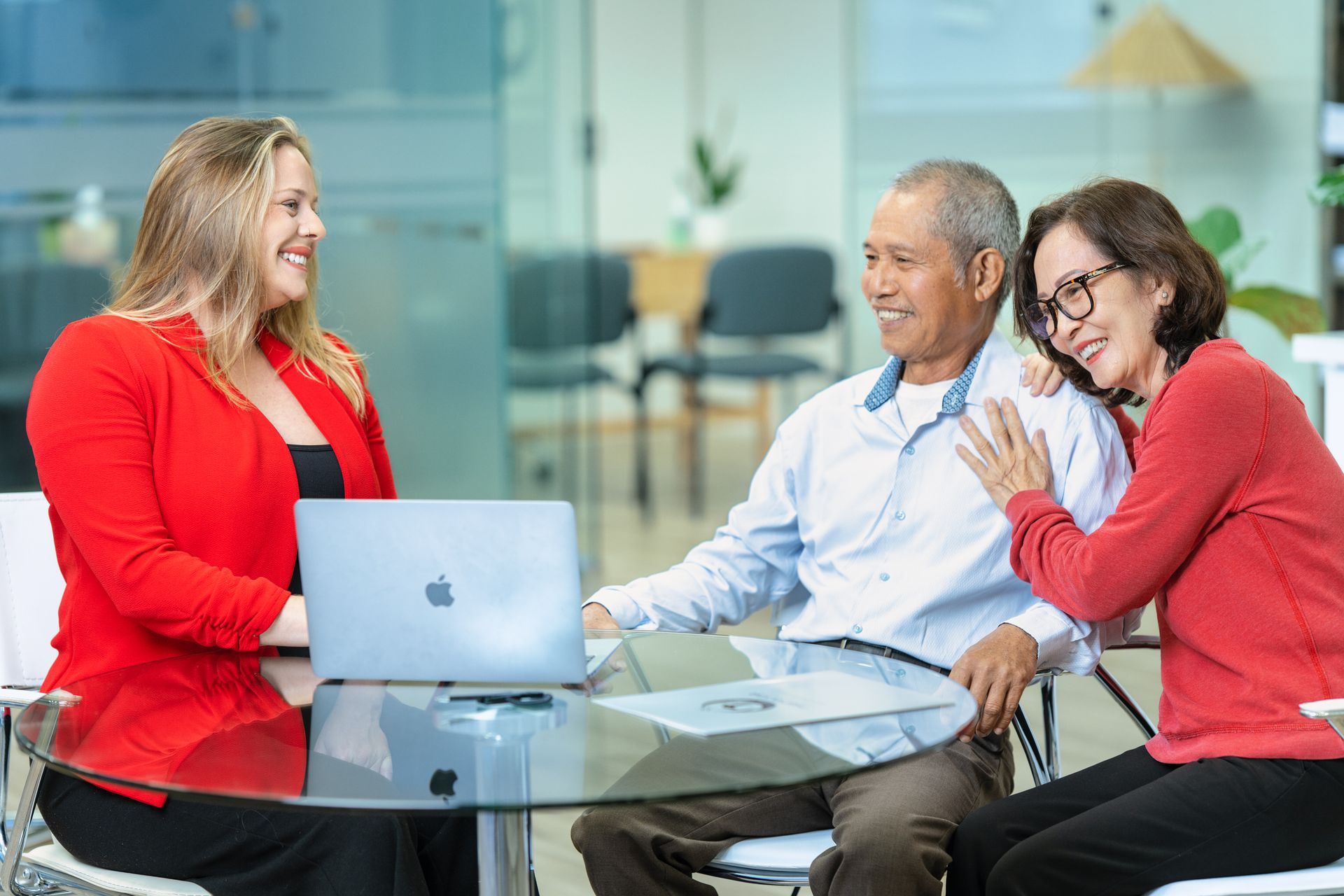 Professional advisor consulting with a couple in a modern office, focusing on financial guidance and trust.