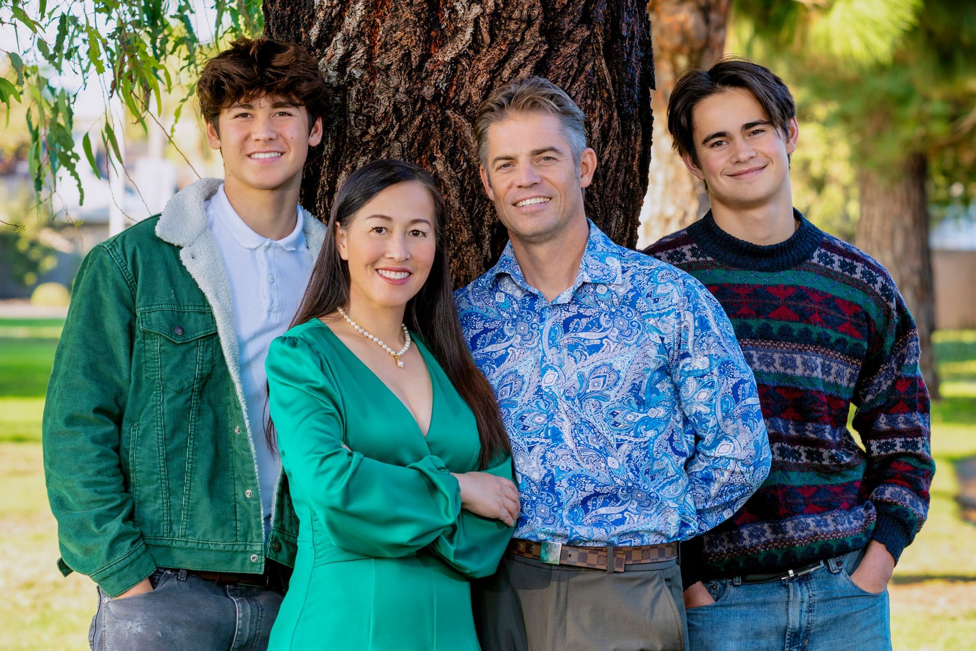 A family portrait taken at a park.