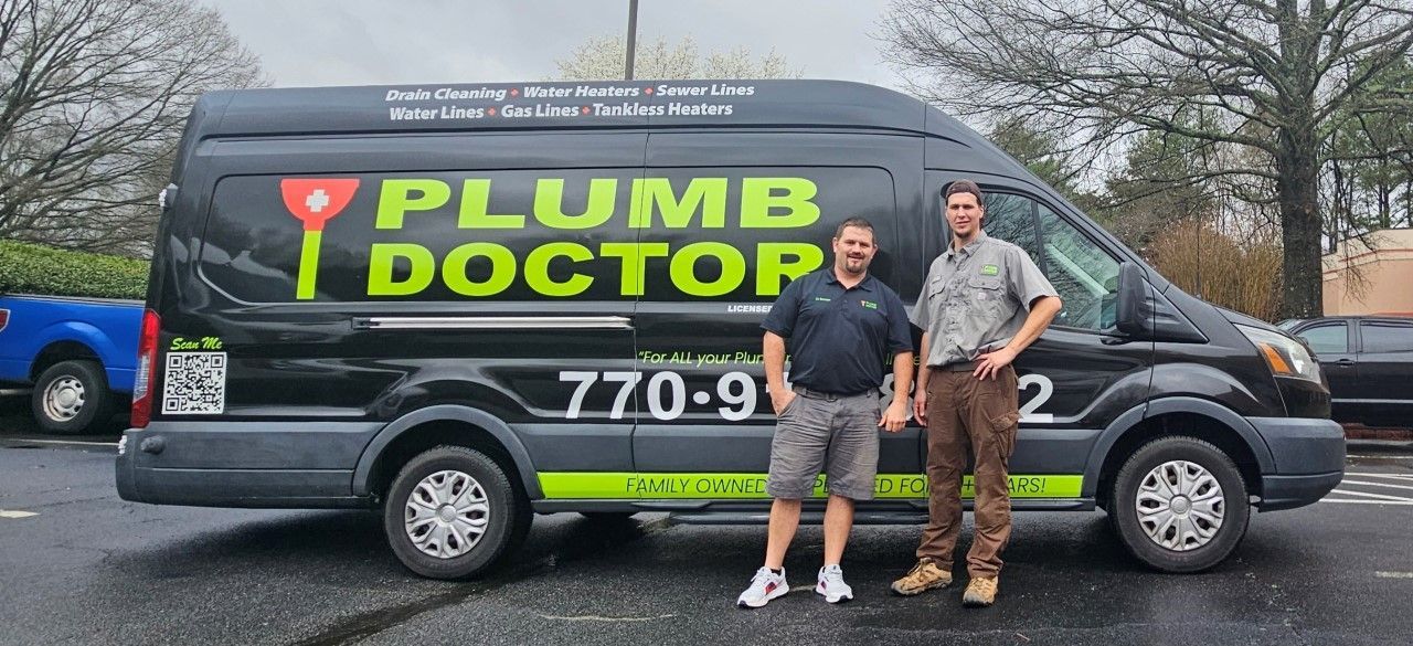 Two men are standing in front of a plumb doctor van.