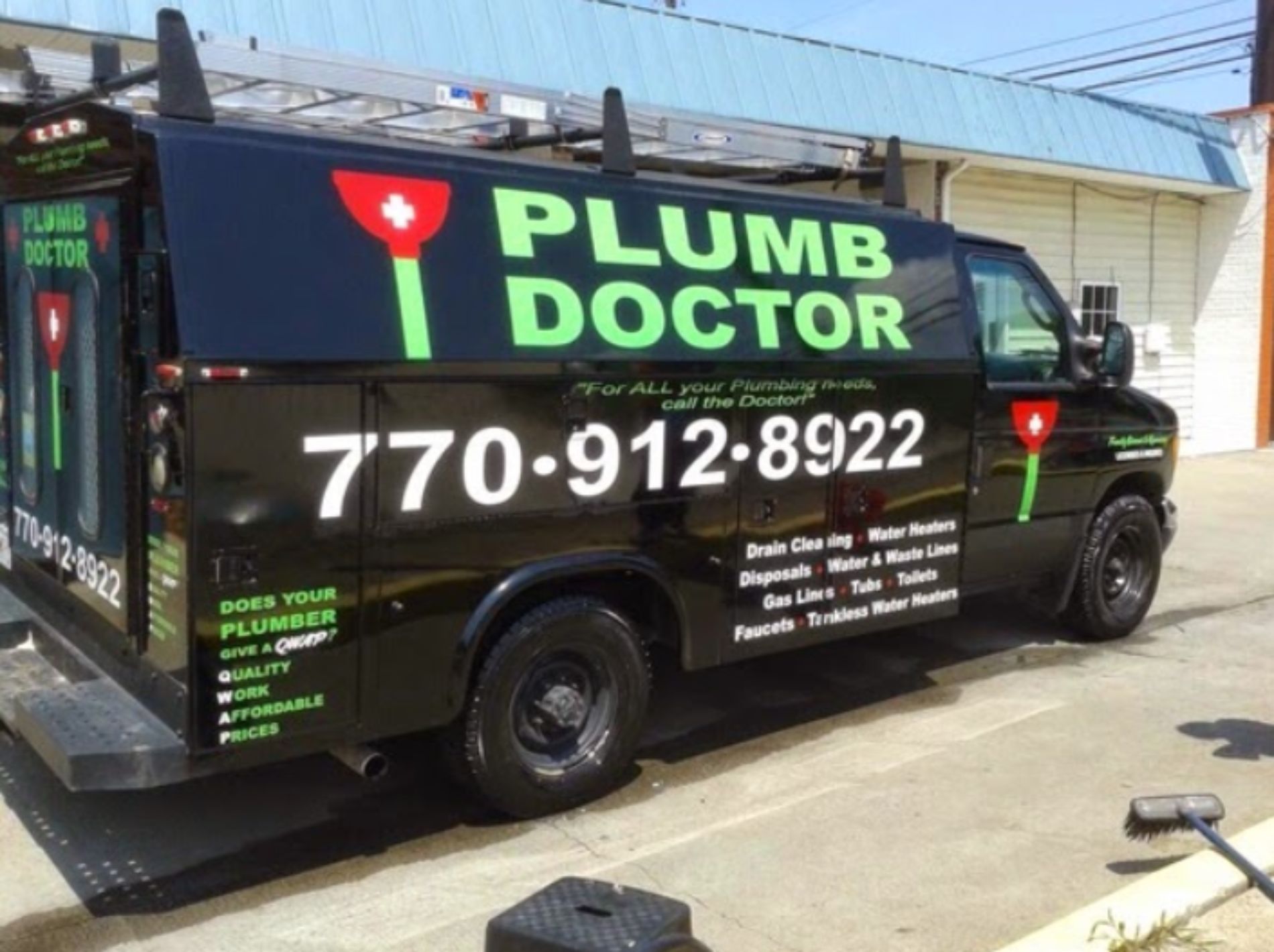 A plumb doctor van is parked in front of a building