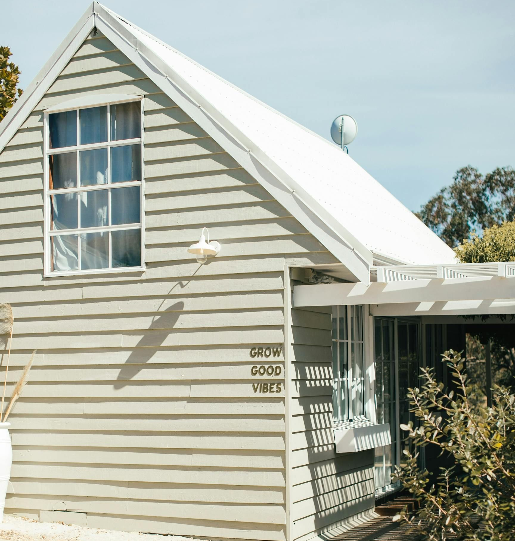 A man is kneeling down and painting a wall with a roller.