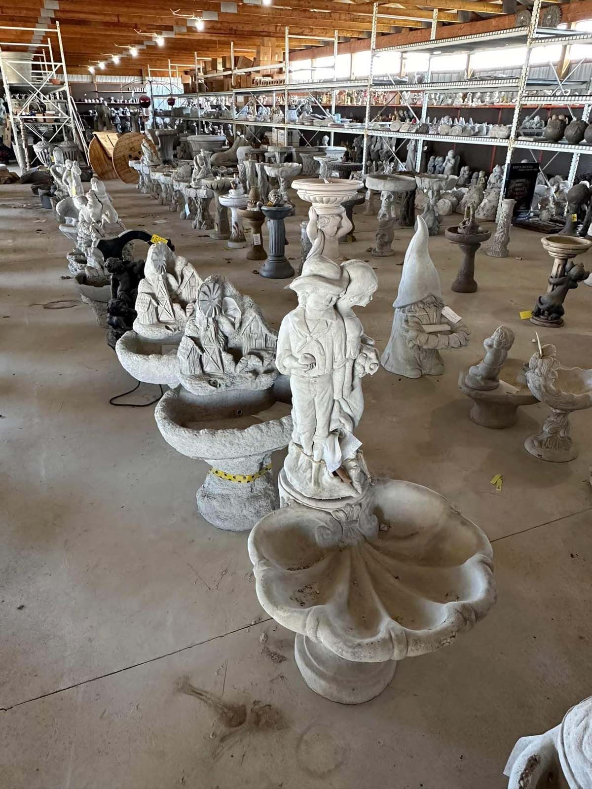 A large warehouse filled with lots of statues and fountains.