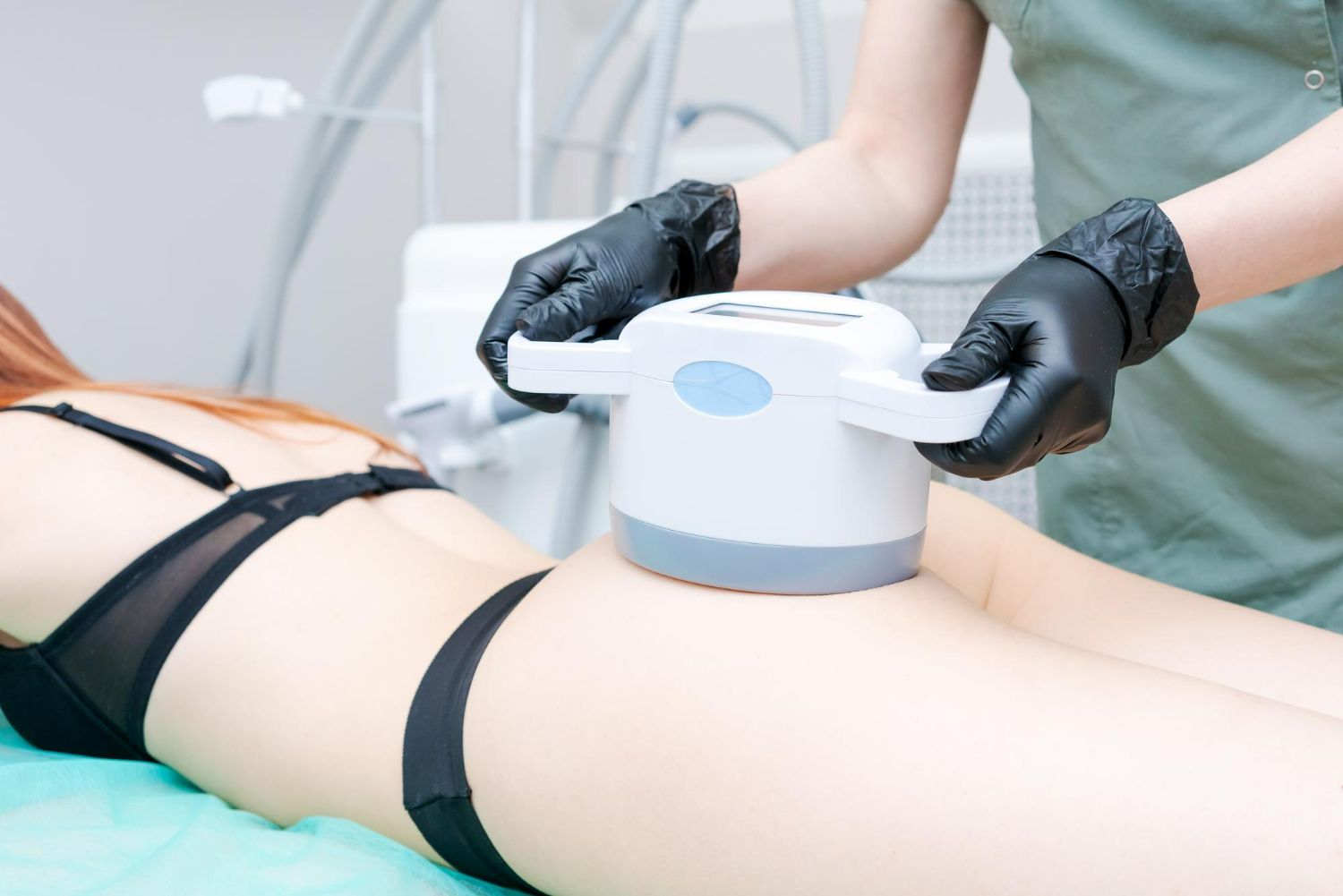 A woman in a bikini is getting a massage from a doctor.