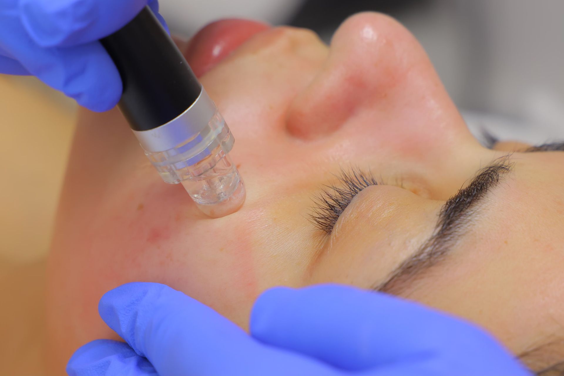 A woman is getting a facial treatment at a beauty salon.