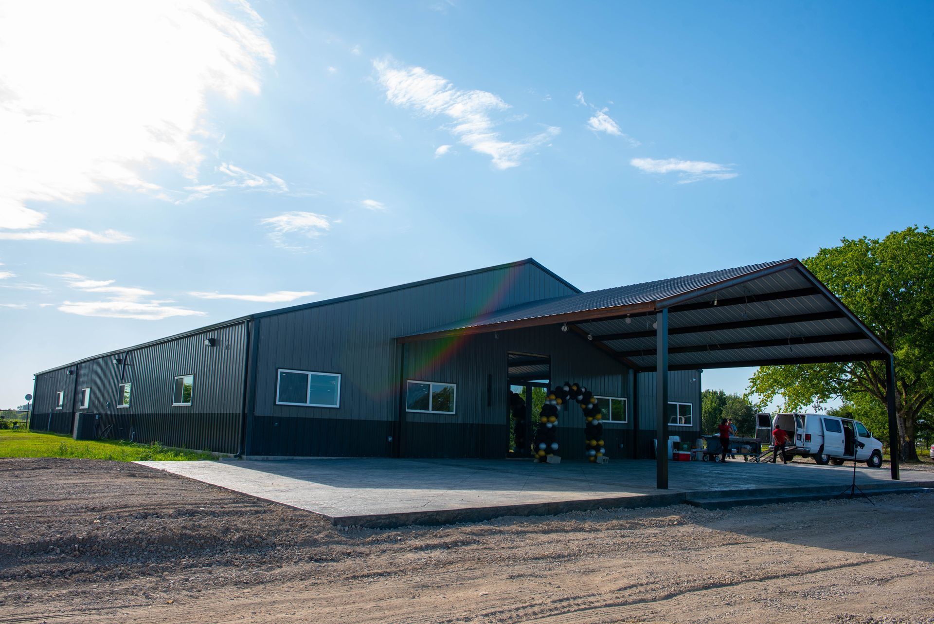 Modern metal building with a covered entrance on a sunny day