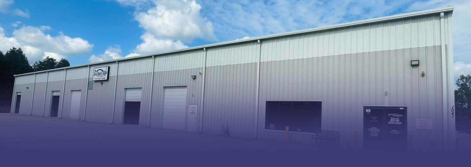 B&S Body Shop exterior with a white pickup truck parked outside, on a sunny day.