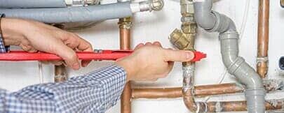 Plumber fixing the heating system — sewer line service in Ozark, MO