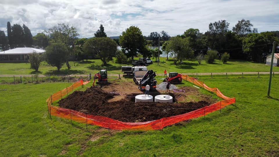 A Large Pile of Dirt Is Sitting in The Middle of A Field — Matt King Plumbing & Septic Systems in Taree, NSW