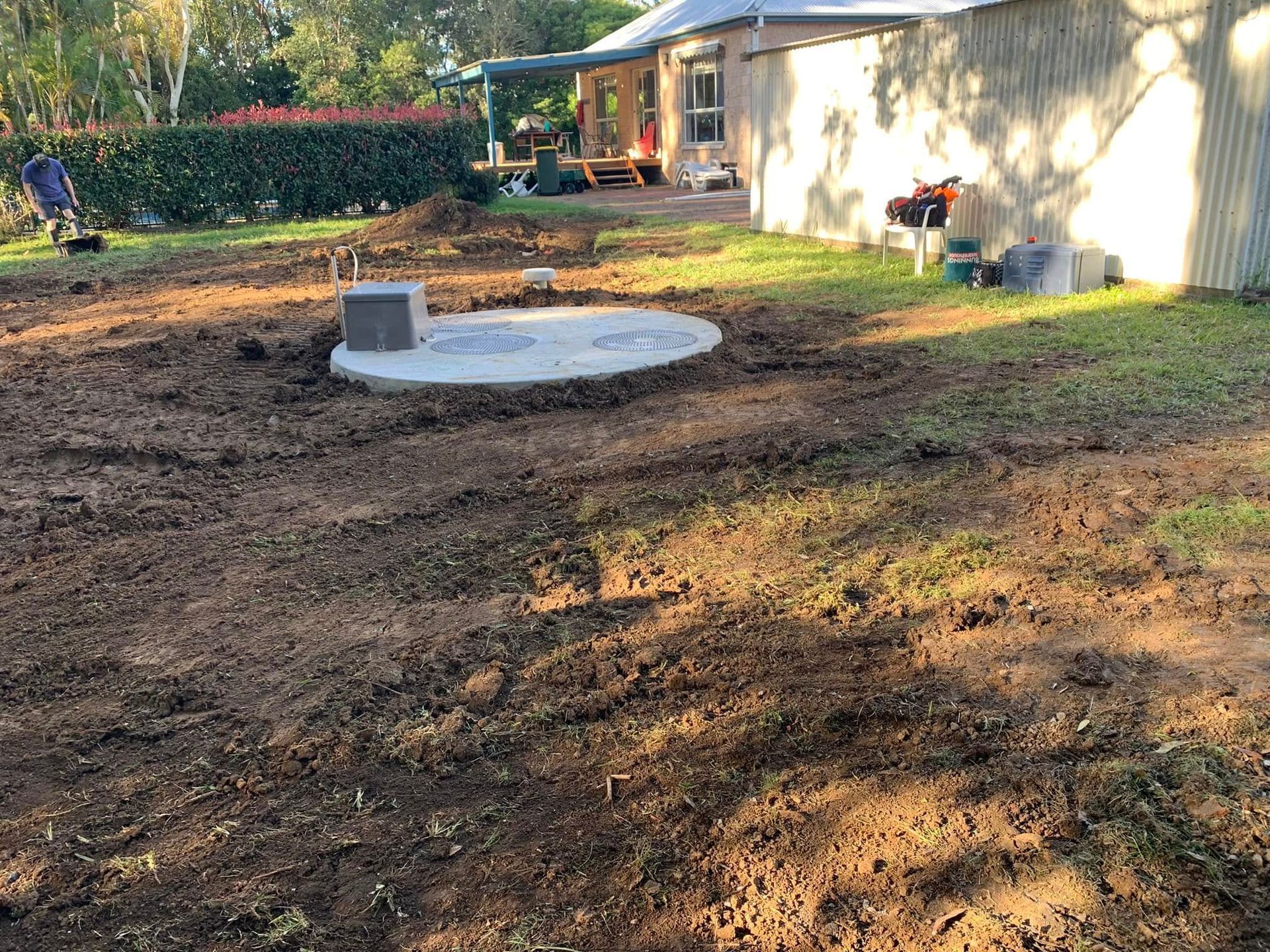 A Large Concrete Septic Tank Is Being Installed in A Field — Matt King Plumbing & Septic Systems in Taree, NSW