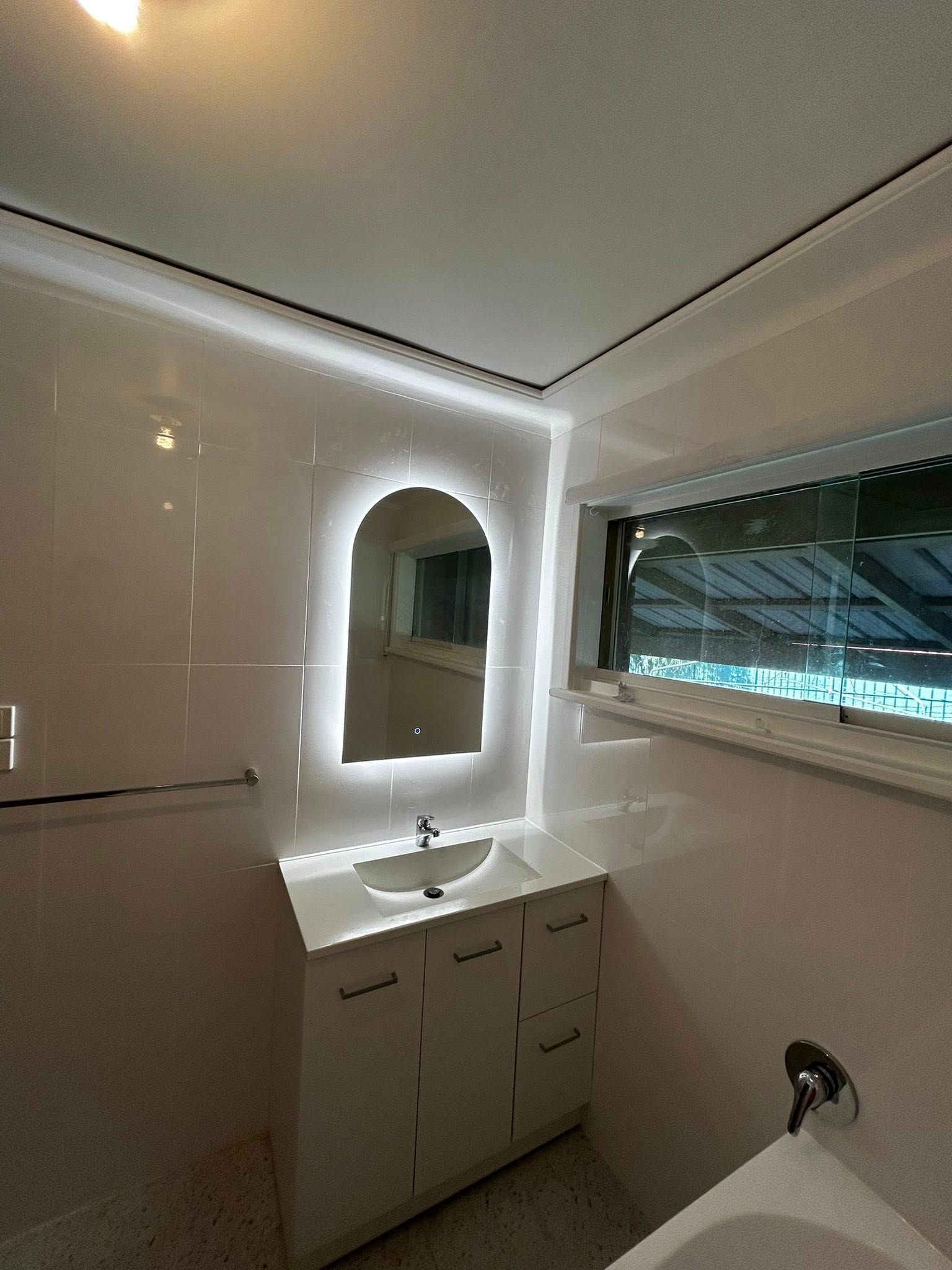 A bathroom with a sink , mirror and tub — Matt King Plumbing & Septic Systems in Taree, NSW