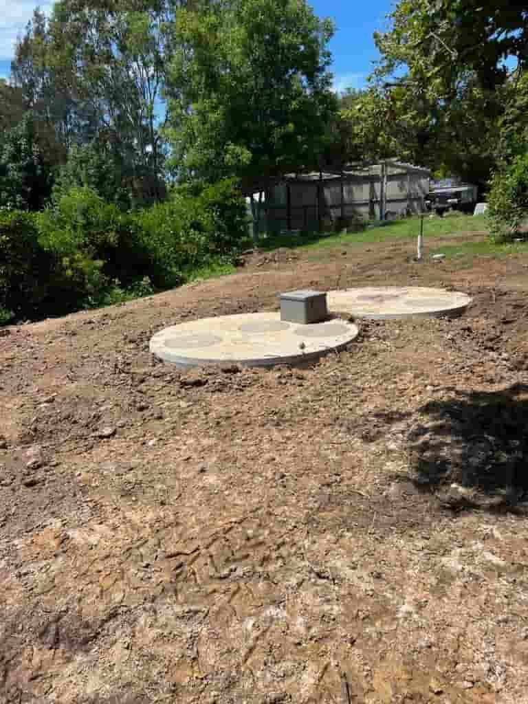 Two Septic Tanks Are Sitting on Top of A Dirt Hill — Matt King Plumbing & Septic Systems in Taree, NSW