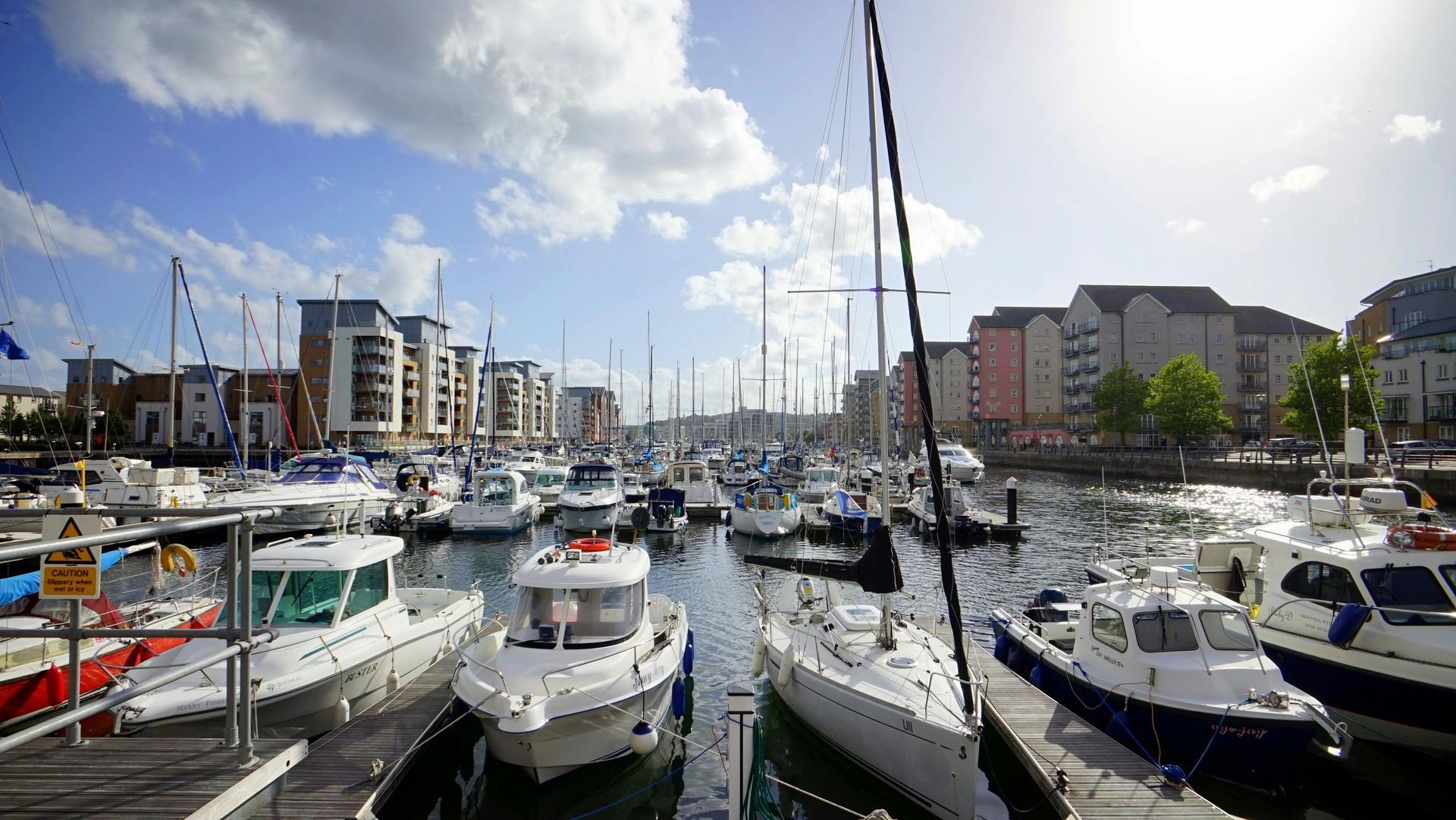 A bunch of boats are docked in a harbor.