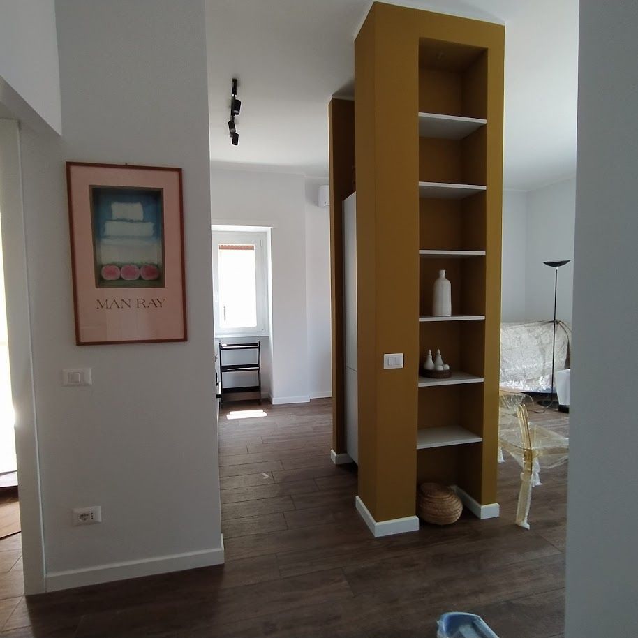 Open space soggiorno cucina ristrutturazione appartamento Roma Garbatella