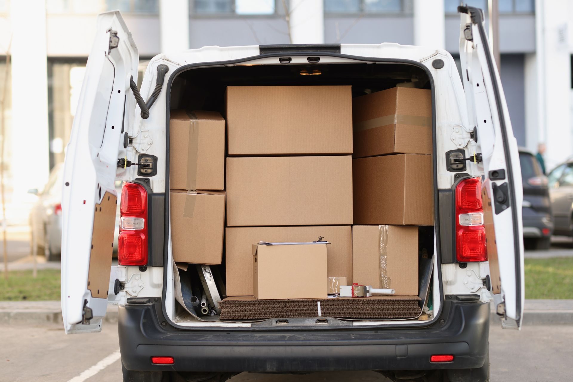 Open cargo van filled with cardboard boxes for delivery