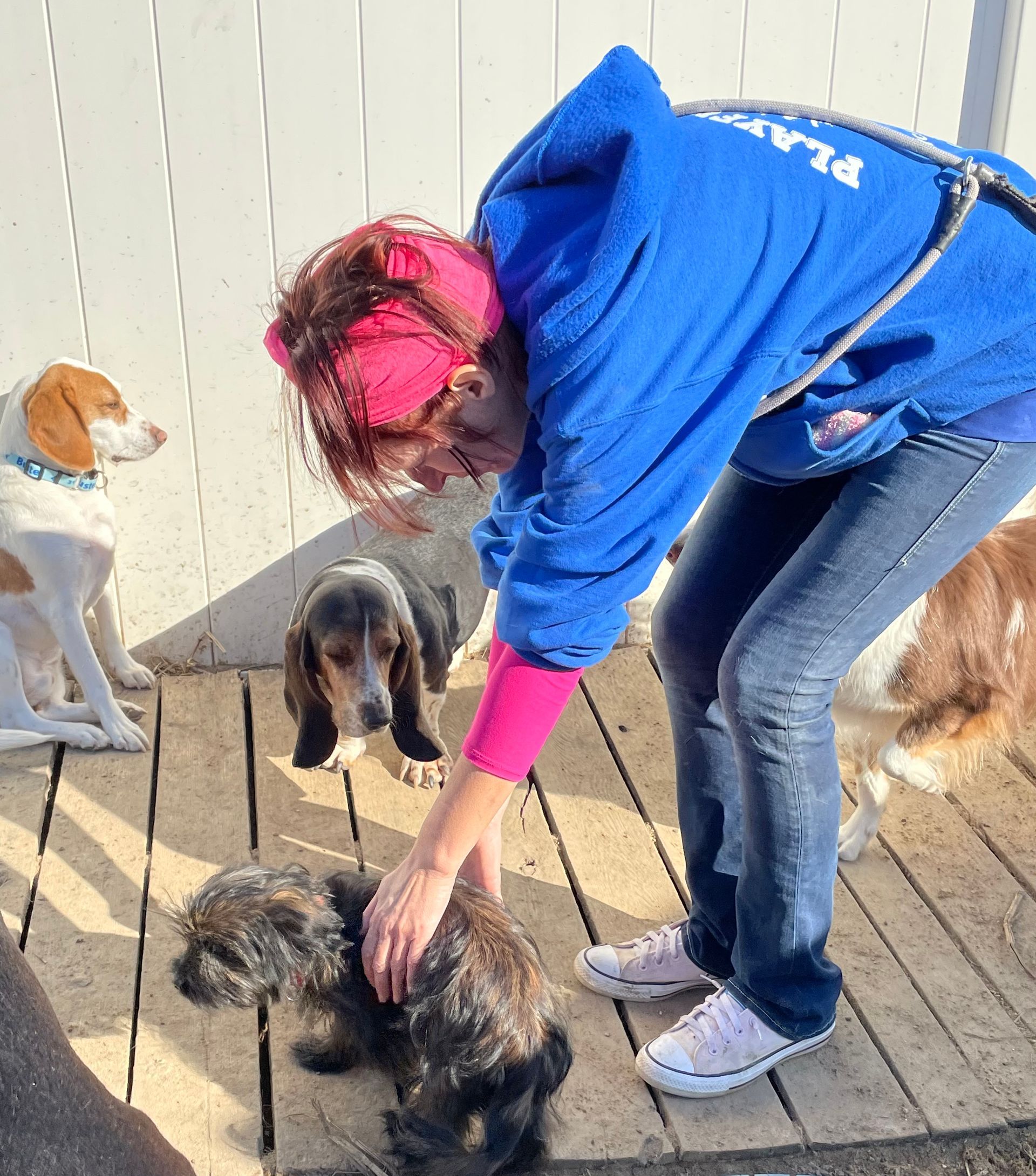 A woman in a blue hoodie with the word plan on it
