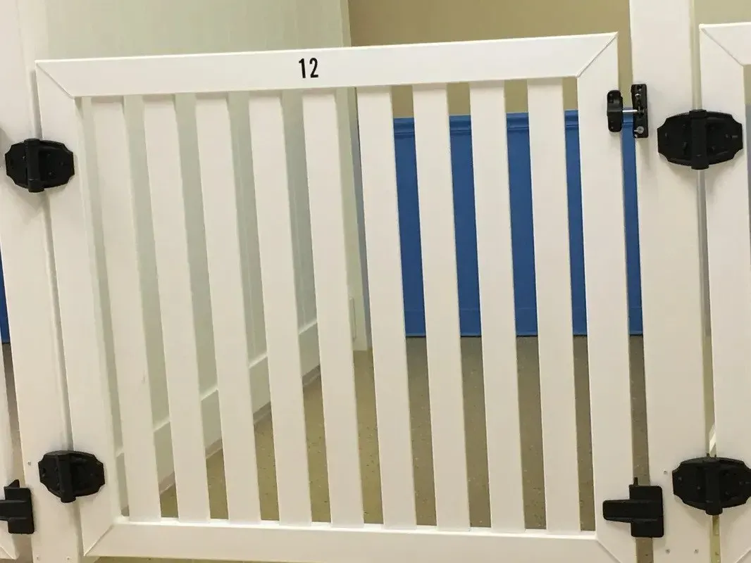 A white gate with the number 12 on it