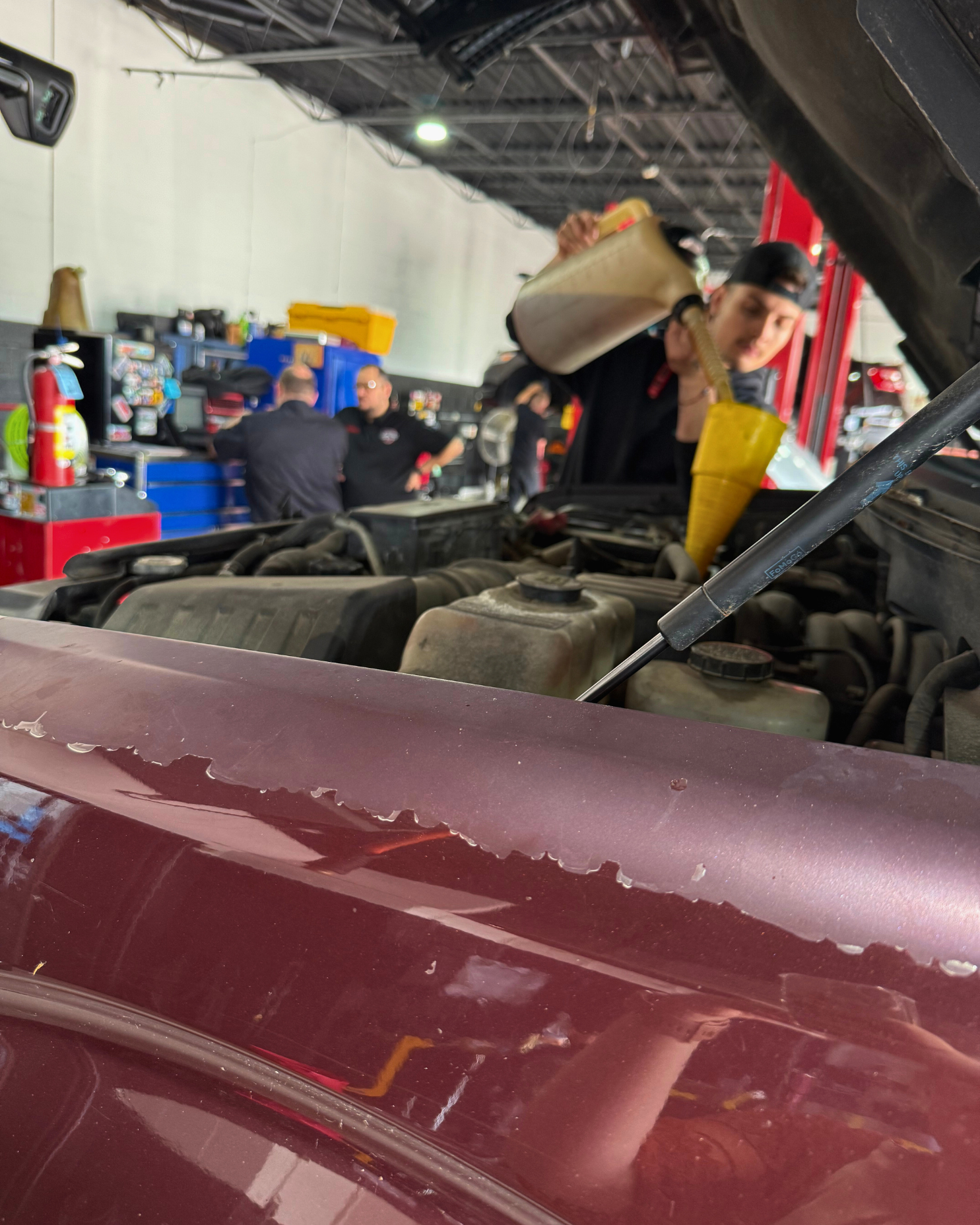 Mechanic pouring oil into a car engine | Righteous Auto Care