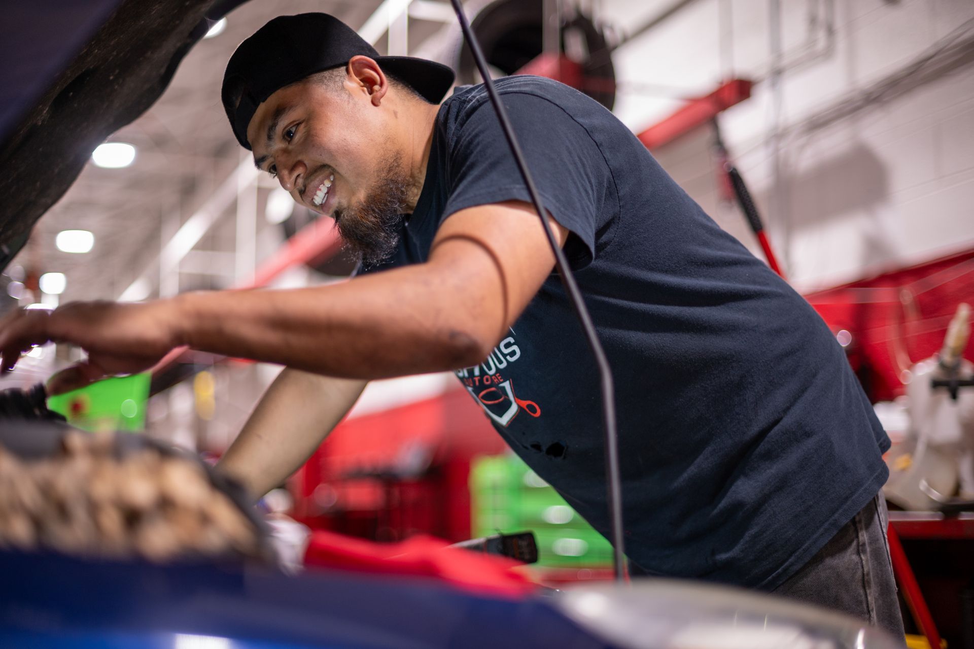 Mechanic in a garage, working on a car engine | Righteous Auto Care