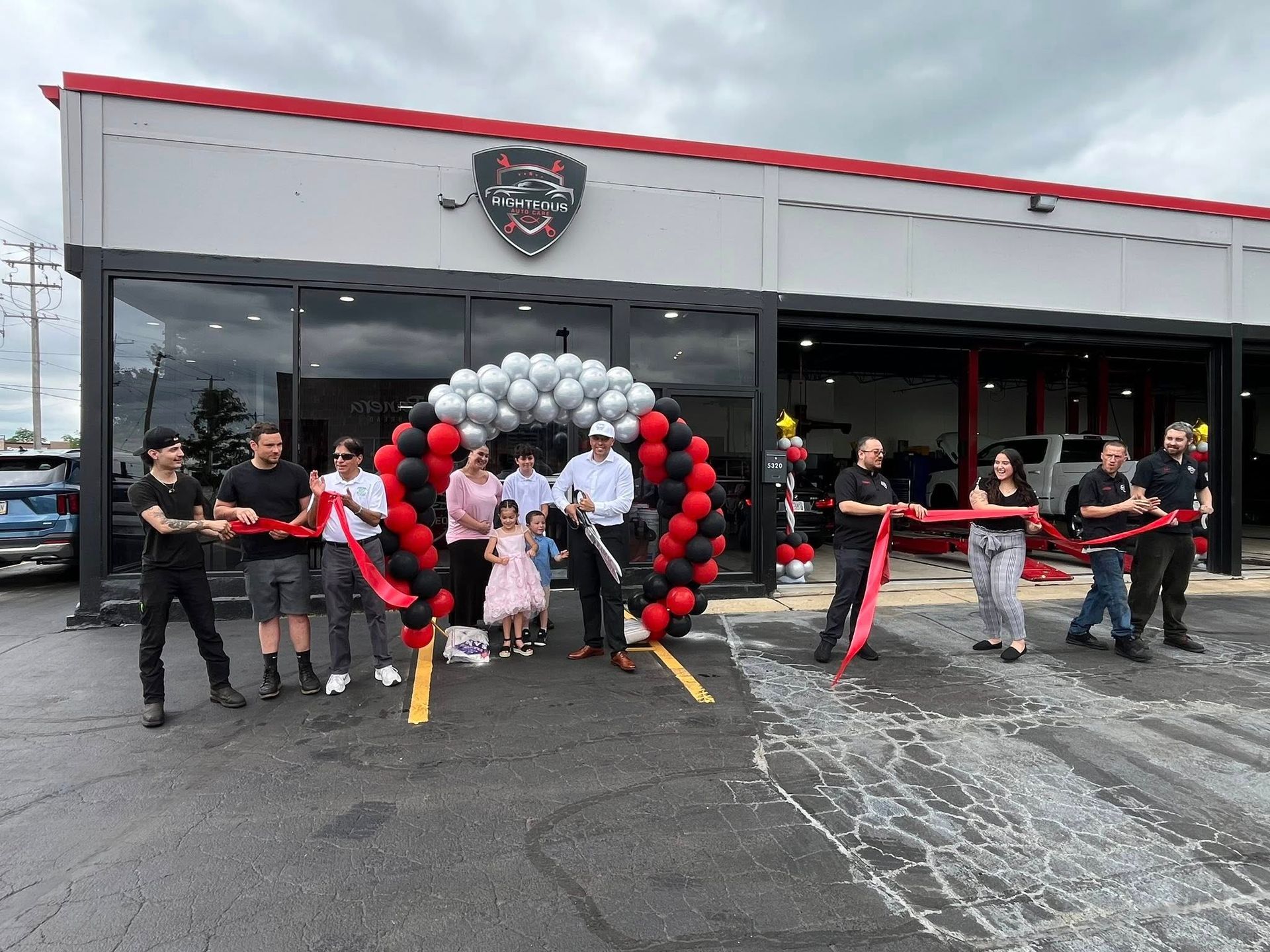 People cut a ribbon at the grand opening of the shop | Righteous Auto Care