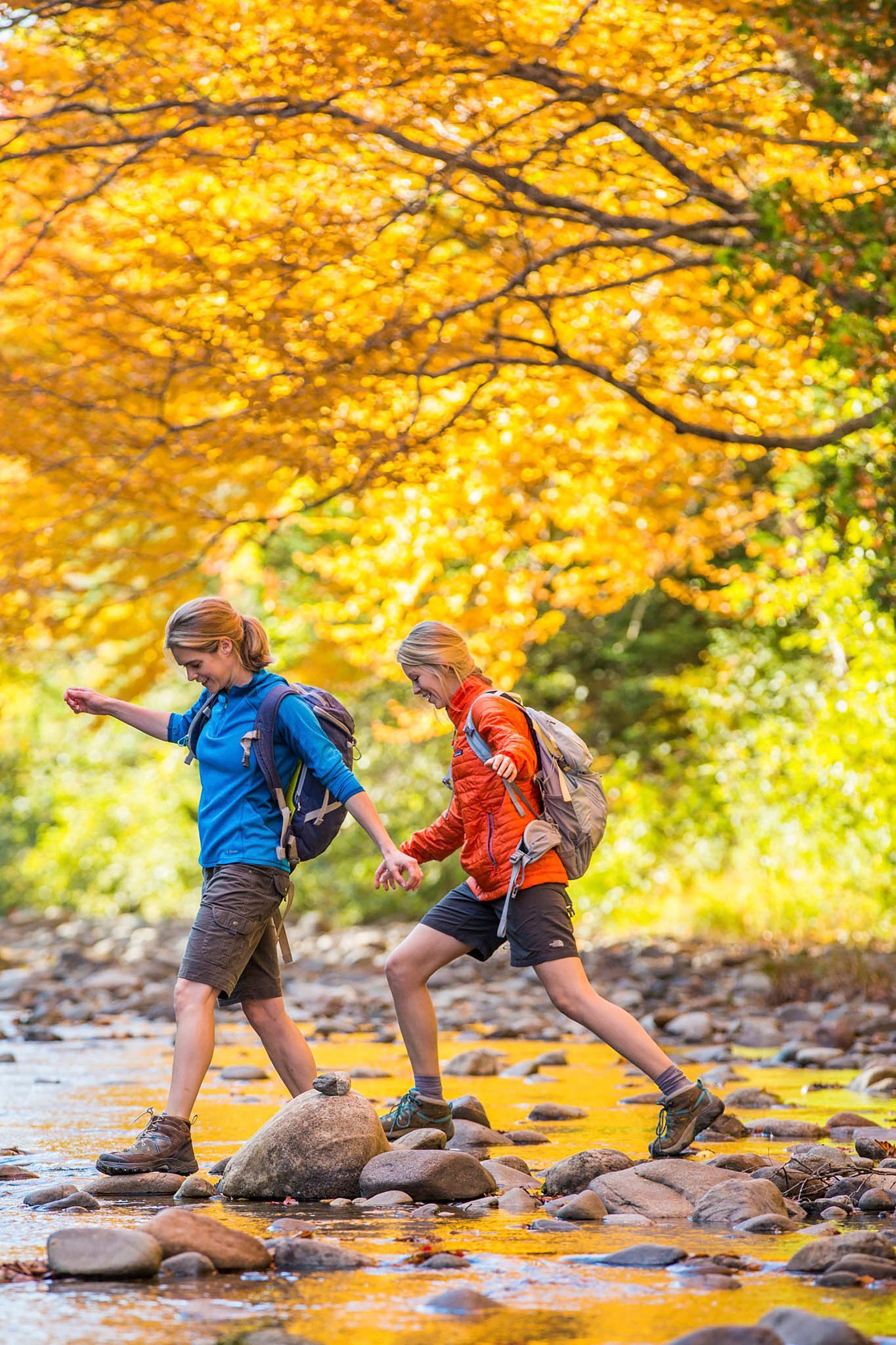 hiking across river with fall colors
