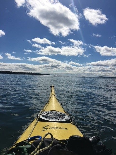 view of partly cloudy sky and open water, from a sea kayak.