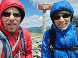 Two men wearing L.L.Bean Packaway Primaloft Hooded Jackets, on a summit on the Appalachian Trail.