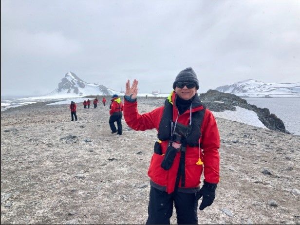 A man standing on a glacier wearing a ragg wool hat