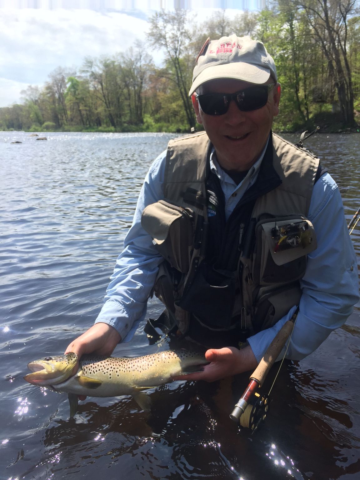 Steve J. holding a trout caught on a fly rod