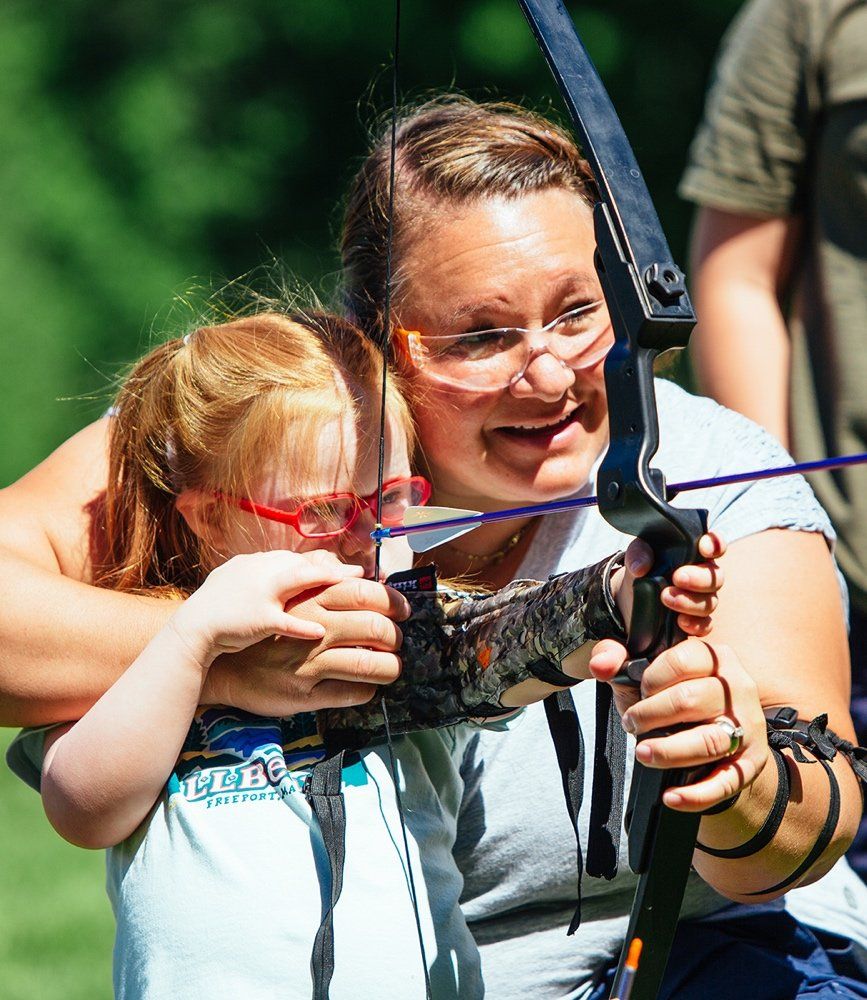 Mother and daughter learning archery