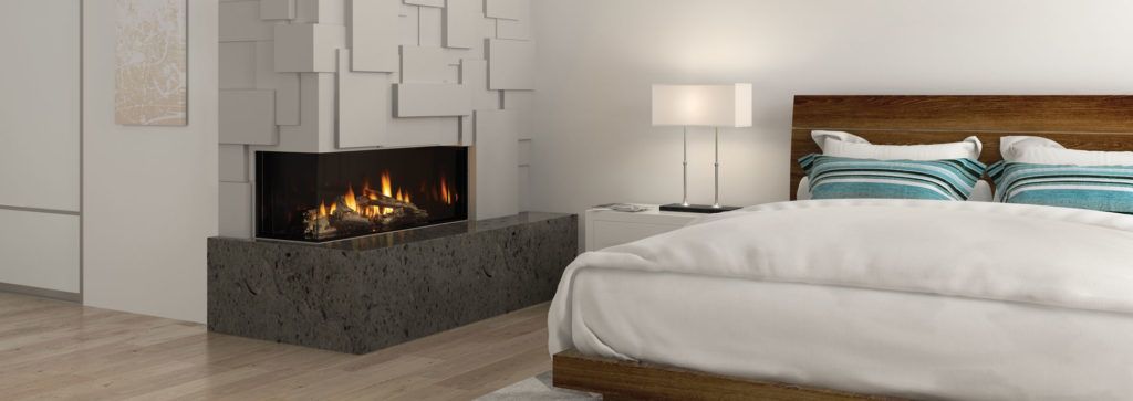 A see through fireplace in a bedroom space with a beautiful paneled wall.