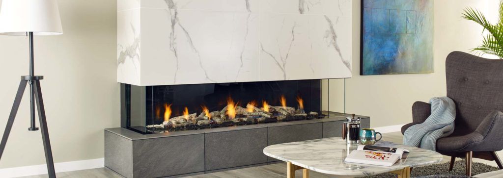 A three sided fireplace in a modern living space.