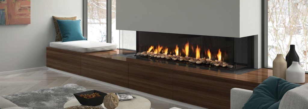 A three sided fireplace in a modern living space with inbuilt storage beneath.
