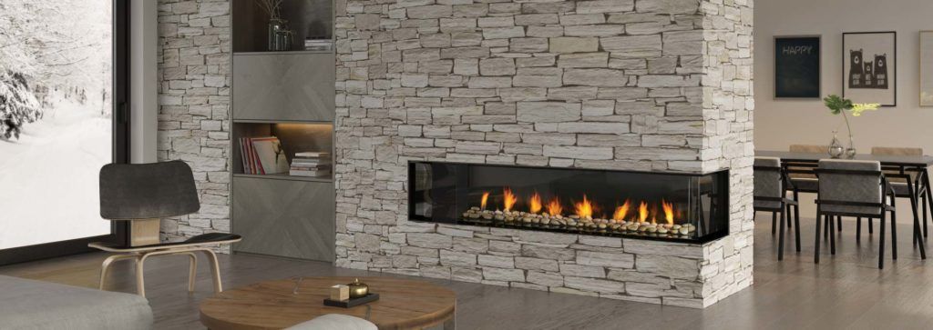 A corner fireplace in a modern living space with a stone veneer wall.