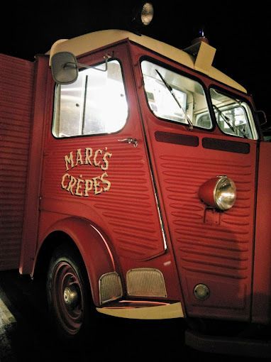 A red truck that says marc 's crepes on the side