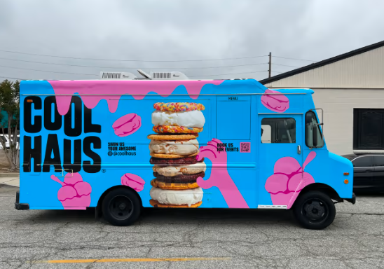 A blue and pink food truck that says cool haus