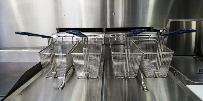 several metal baskets on a stainless steel surface