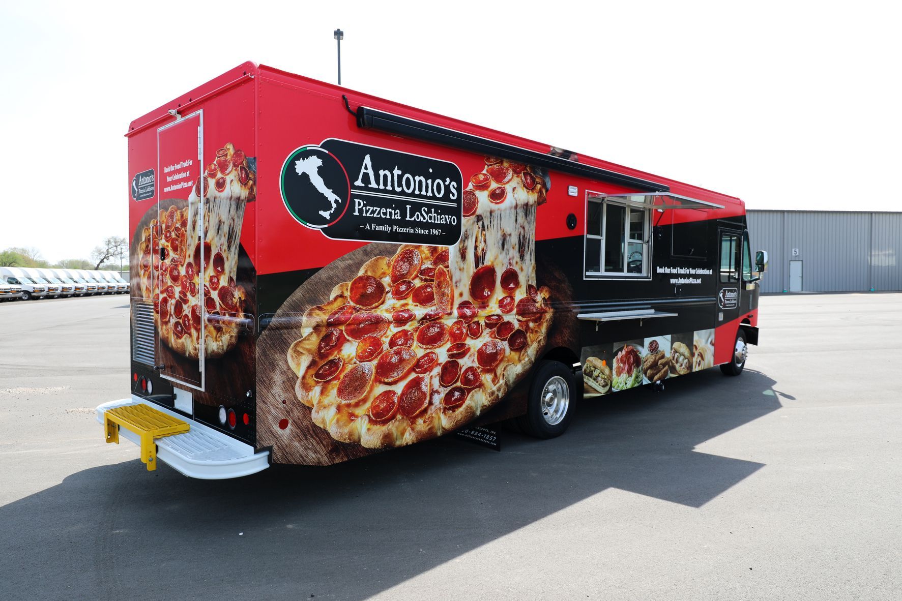 A red and black food truck with a pepperoni pizza on it