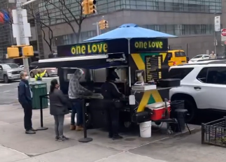 A food truck that says one love on it
